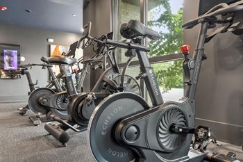 Cardio and strength training fitness center with eschelon and peloton bikes and fitness mirrors